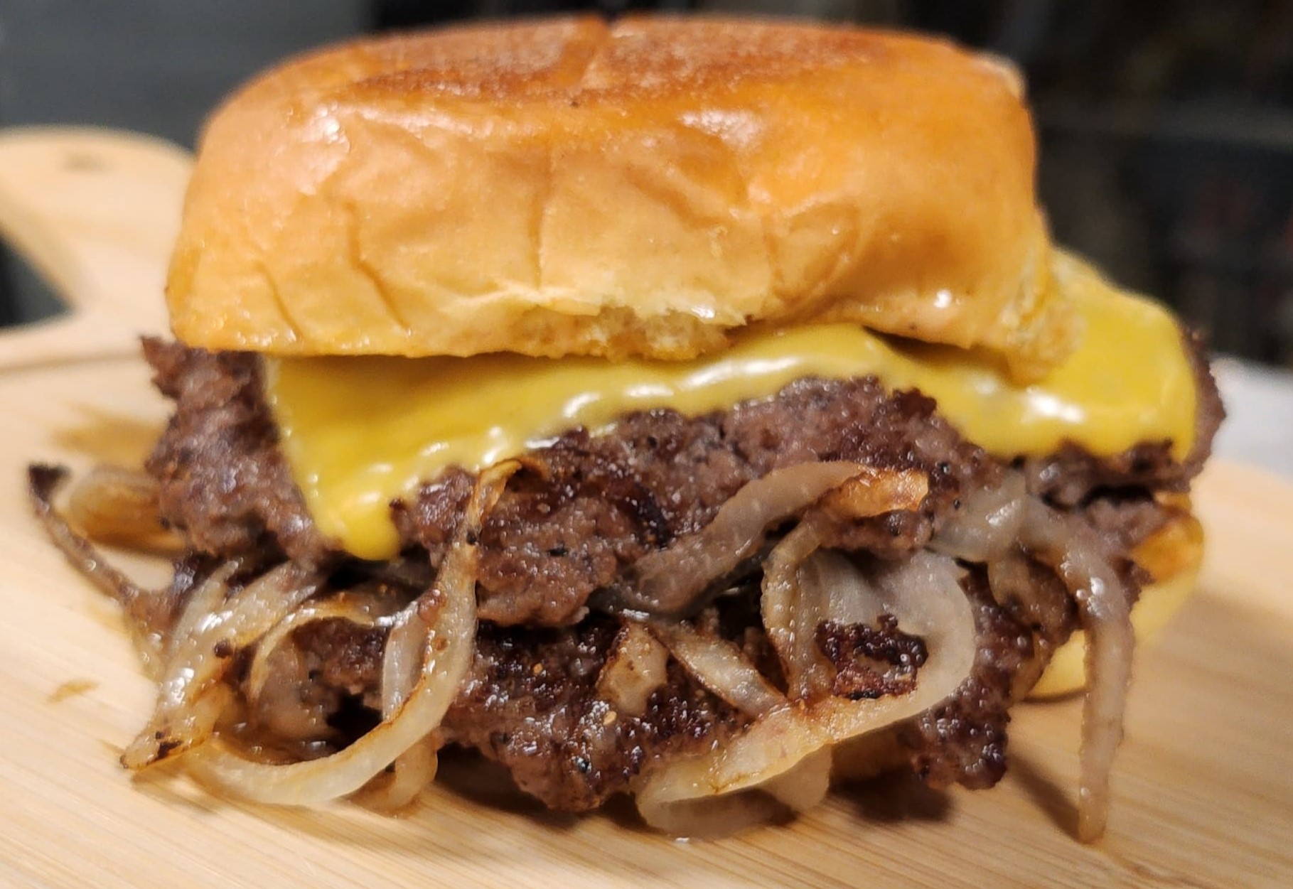 Smashed Certified Angus Beef burger with melted cheese and onions.